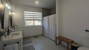 a bathroom with a sink and a shower with a window at Wheel chair Access, Private Boat Launch in Roseneath +66 photos