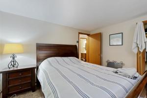 a bedroom with a large bed with a wooden headboard at Green Mountain Escape in Wilmington