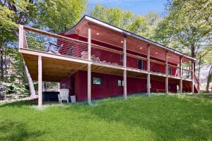 a large red house with a deck on top of it at Green Mountain Escape in Wilmington