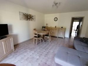 a living room with a table and a couch at air-conditioned apartment with pool plus beach shuttle in Mandelieu-La Napoule
