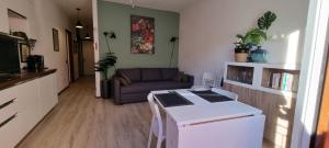a living room with a couch and a table at Lakeview Casa Camelia 21 in Acquaseria