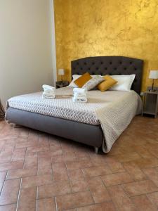 a bedroom with a large bed with yellow pillows at La Dolce Vita in Cascia