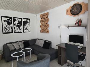 a living room with a couch and a clock on the wall at Laredo top hotel boutique in Santiago