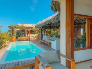 a villa with a swimming pool and a patio at La Villa Dune, um luxo com vista espetacular por mar e coqueiral ! Uma experiência unica ! in Icaraí
