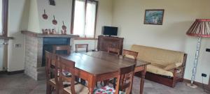 a dining room with a table and a fireplace at Casa vacanza Da Lara in Poggio Ferrato