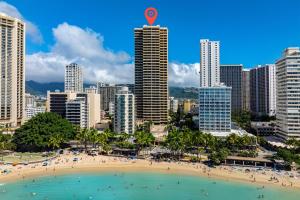 a beach in front of a city with buildings at Aston Waikiki Beach Tower 602 in Honolulu