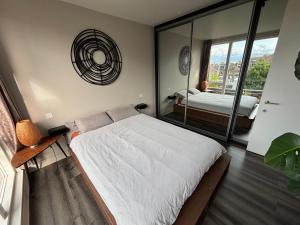 a bedroom with a bed and a large window at Panoramic Pondview Penthouse in London
