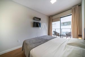 a bedroom with a bed and a large window at Apart Villa Francione in Bombas +28 photos