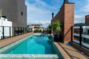 a swimming pool on the roof of a building at Apart Villa Francione in Bombas