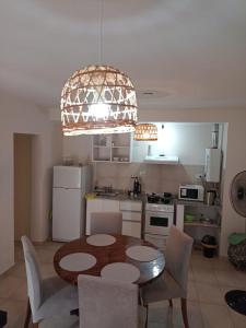 a kitchen with a table and chairs in a kitchen at Casita de Tucuman in San Miguel de Tucumán