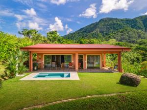 a villa with a pool in the middle of a yard at Villa Roca Ocean to Mountain Views - by Pura Villas in Ojochal
