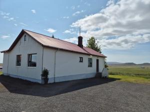 a white building with a red roof at Stóraborg Guesthouse in Grímsnes og Grafningshreppur