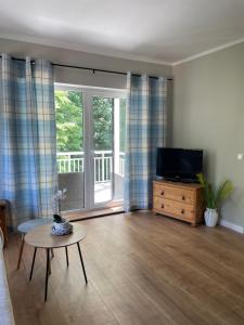 a living room with a television and a table at Seeperle in Lalendorf