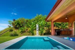 a swimming pool in the backyard of a house at Villa Roca Ocean to Mountain Views - by Pura Villas in Ojochal