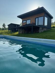 a house with a swimming pool in front of it at DIDO house in Slavske