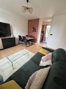 a living room with a couch and a table at La Terrasse Ouest in Thonon-les-Bains