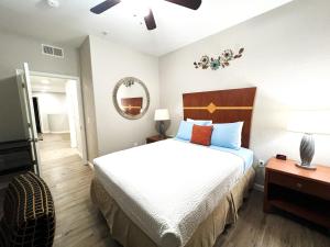 a bedroom with a large bed and a mirror at 365 Sunshine of Yuma in Yuma +14 photos