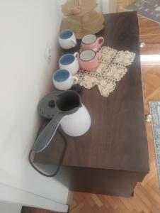 a table with cups and bowls on top of it at BoHan sobe Vladičin Han in Vladičin Han