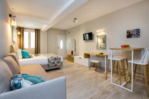a hotel room with a bed and a desk at ALDEBARAN HOMES in Limenaria