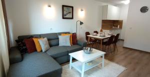 a living room with a couch and a table at Апартамент ДАРА in Smolyan