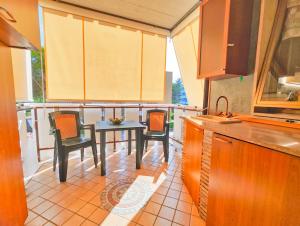 a kitchen with a table and chairs in a kitchen at Apartment VIA RENO in Silvi Marina
