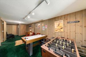 Una habitación con una mesa de ping pong y consolas. en North Conway townhouse Near White Mountains, en Conway