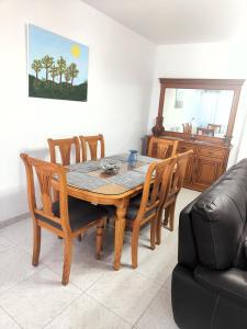 a dining room with a wooden table and chairs at Los Deseos De Vera in La Cala de Mijas