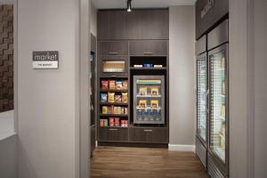 a store aisle with a refrigerator filled with food at Residence Inn by Marriott San Antonio SeaWorld /Westover Hills in San Antonio