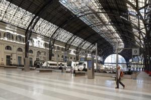 a person walking through a train station with a large ceiling at Pension Ciudadela in Barcelona