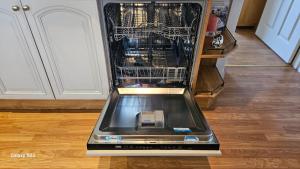 a dishwasher with its door open in a kitchen at Westend House in Goring by Sea