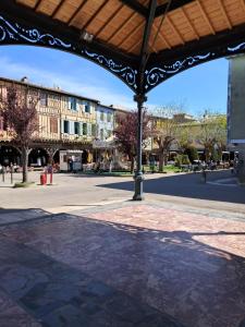 a pavilion with a building in the middle of a street at Gentil coquelicot in Mirepoix