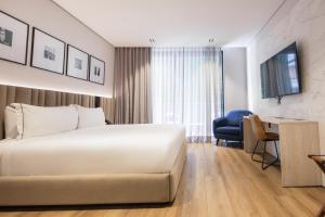 Voodi või voodid majutusasutuse Vuestro Hotel Boutique toas