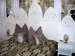 a bedroom with a bed with pillows and windows at Fewo Meissen in Meißen