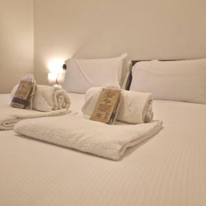 a white bed with towels on top of it at Charming Suite in Center Como in Como