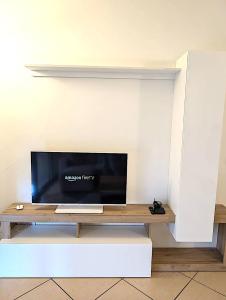 a flat screen tv sitting on top of a table at Charming Suite in Center Como in Como