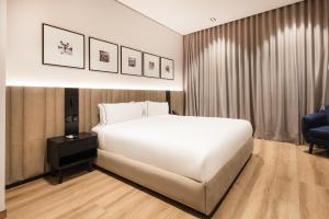 Voodi või voodid majutusasutuse Vuestro Hotel Boutique toas