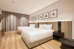 Voodi või voodid majutusasutuse Vuestro Hotel Boutique toas