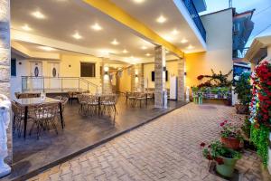 a patio with tables and chairs in a building at ALDEBARAN HOMES in Limenaria