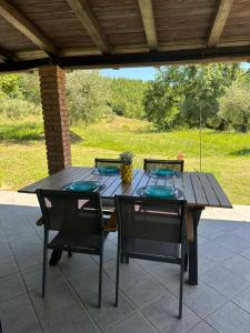 a wooden table and chairs on a patio at Cà di Mora in Lisciano Niccone