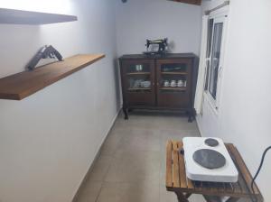 a room with a table and a shelf and a table at Two Palm Trees 1 in Adamantas +4 photos