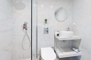 a bathroom with a shower and a toilet and a sink at Hotel Selini in Agios Nikitas