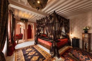 a bedroom with a canopy bed in a room at Dar maya original in Fès