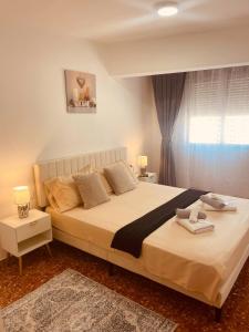 a bedroom with a large bed and a window at Cataleya Apartment in Cullera