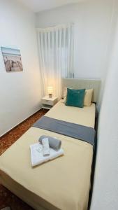 a bedroom with two beds with towels on them at Cataleya Apartment in Cullera +40 photos