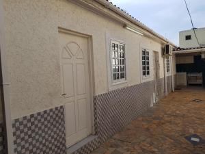 a white door on the side of a building at La Résidence in Lomé