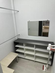 a bathroom with a sink and a mirror on the wall at Frunze Apartment in Bishkek