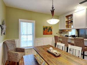 a kitchen and dining room with a table and chairs at Sand Piper in Seacrest +41 photos