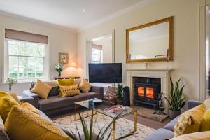 a living room with a couch and a fire place at Telegraph House by inspirestays-com in Chichester