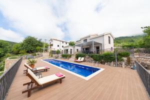 a backyard with a swimming pool and a house at Villa Mattson in Budva