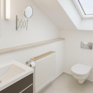 a white bathroom with a toilet and a mirror at Ü Villa Family & Friends 150qm in Hirschaid +31 photos